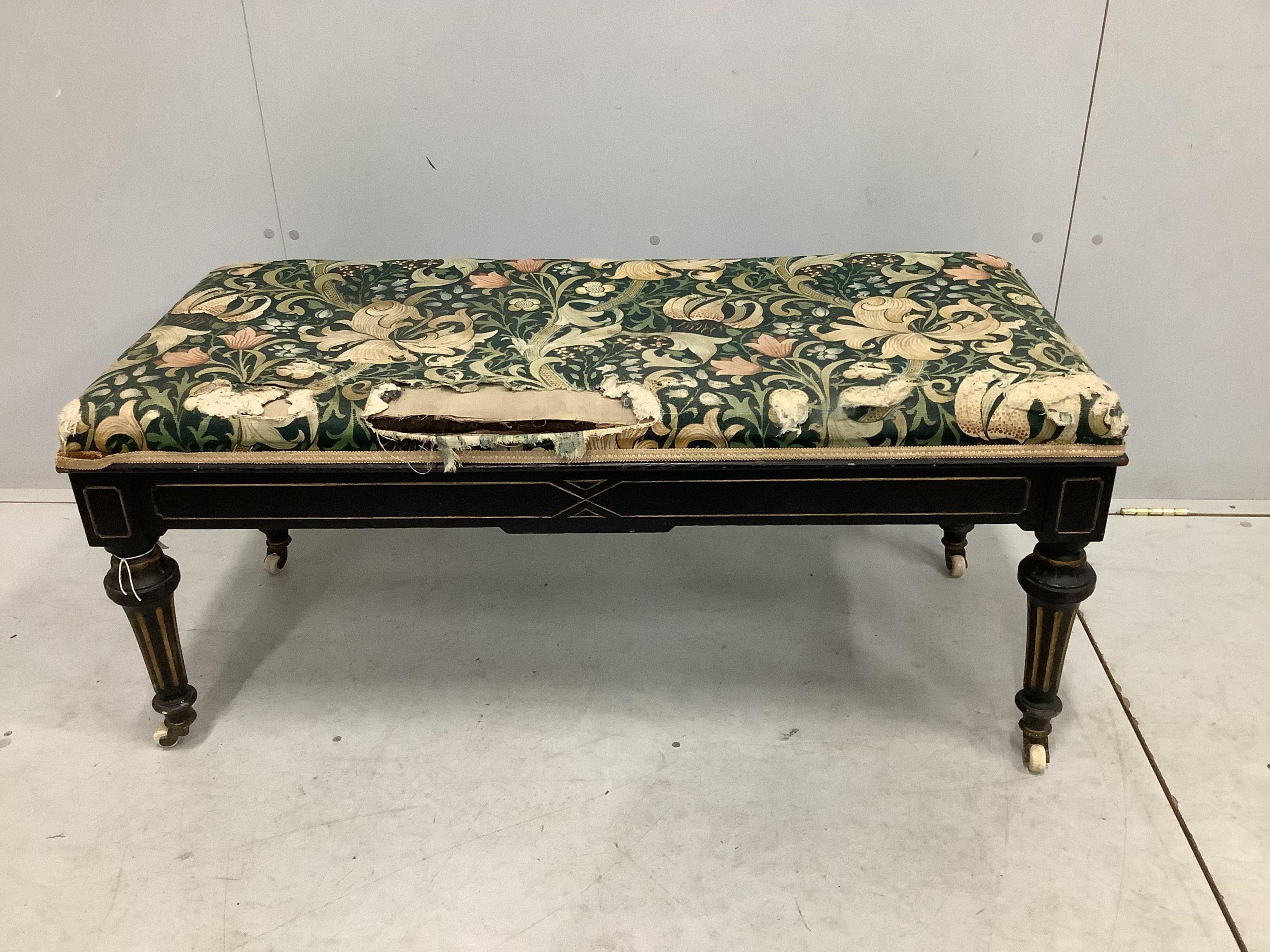 A late Victorian ebonised stool with hinged box seat, width 113cm, depth 49cm, height 50cm. Condition - fair, upholstery poor